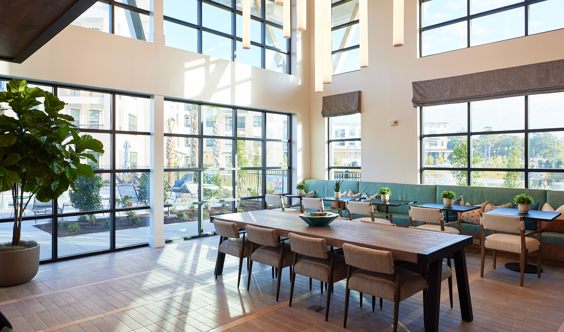 a room with a table chairs and a large window