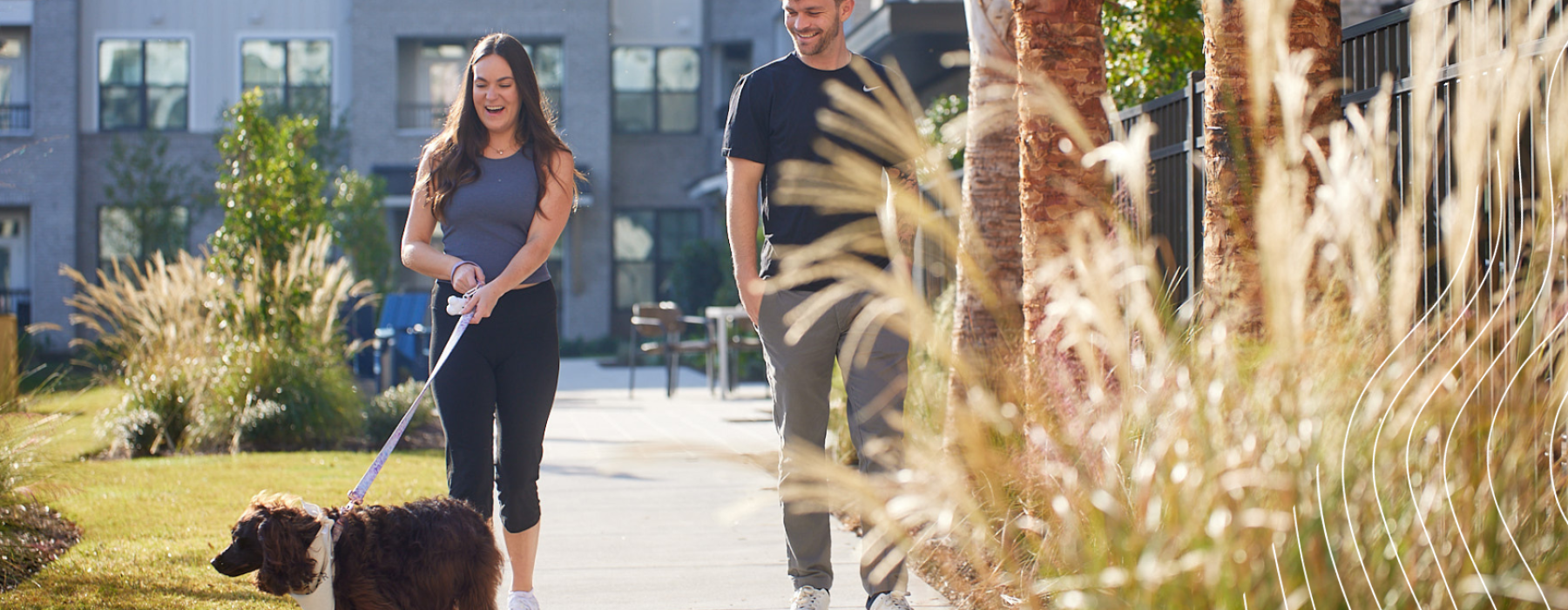 Residents walking pet on walking trail